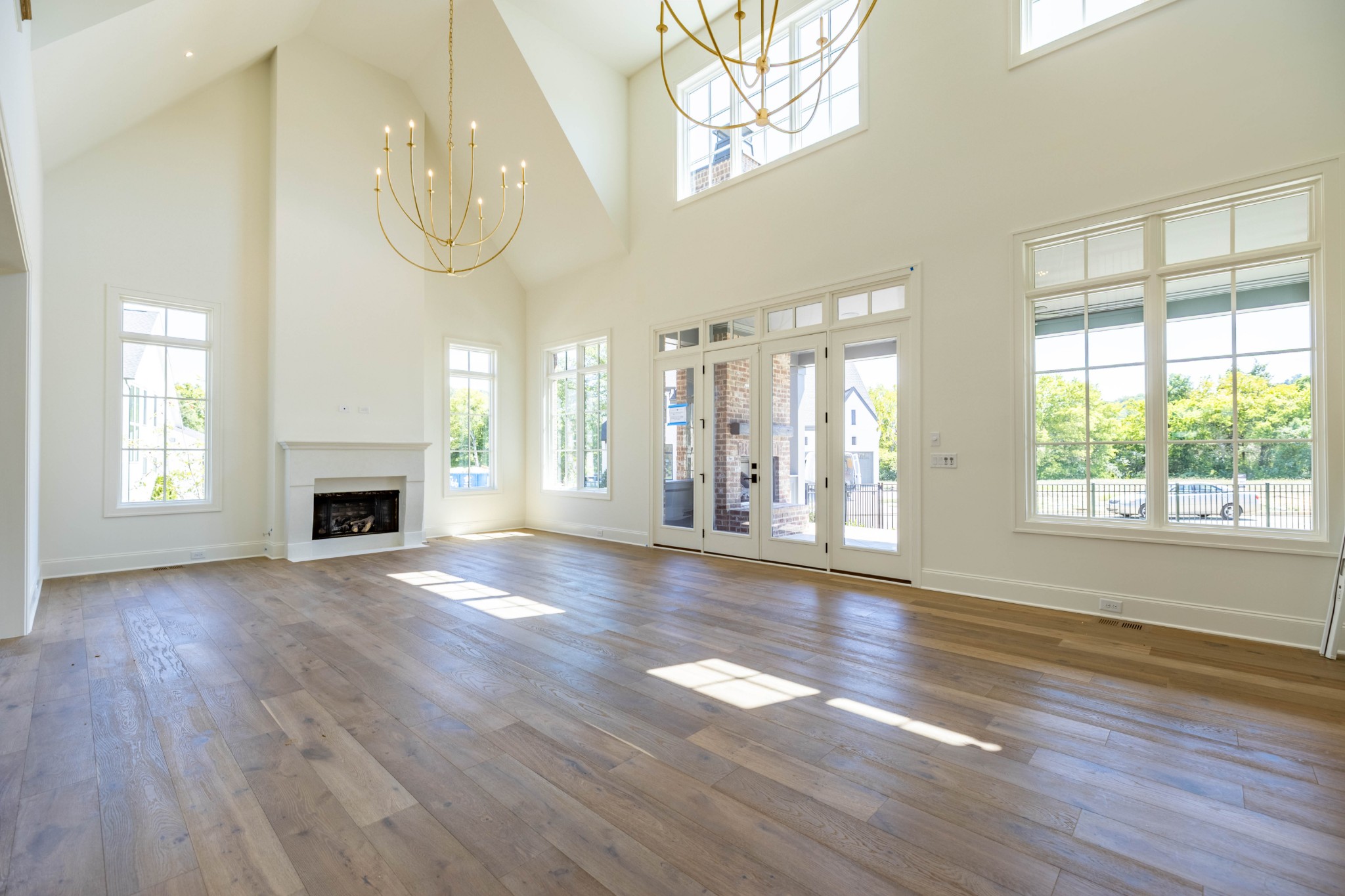 7017 Kinderhook Road Nashville, TN 37221 - Photo 5 of 43 an empty room with wooden floor fireplace and windows