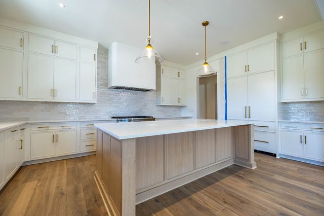 a kitchen with a sink window and cabinets