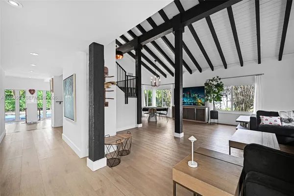 a living room with furniture and a floor to ceiling window