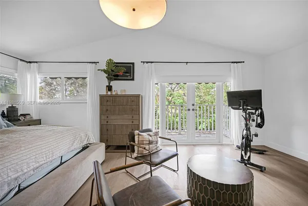 a bedroom with furniture and a window