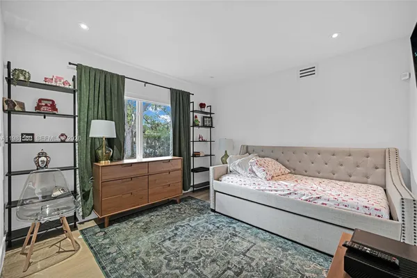 a bedroom with a bed and a couch