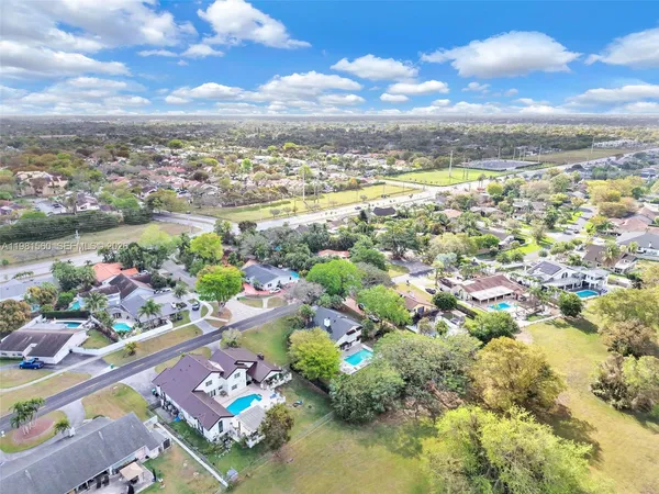 a front view of a house with a yard and potted plants