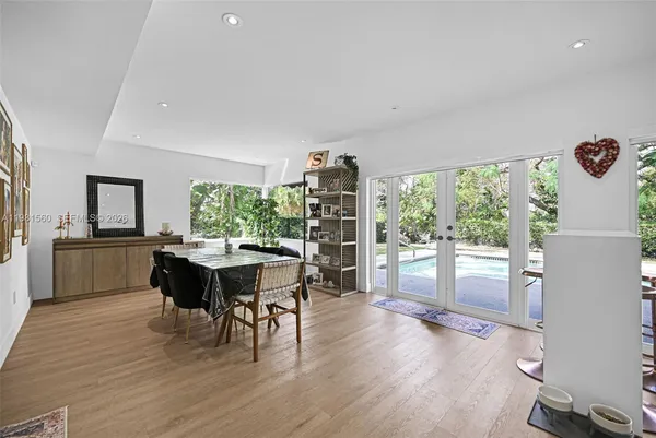 a dining room with furniture and wooden floor