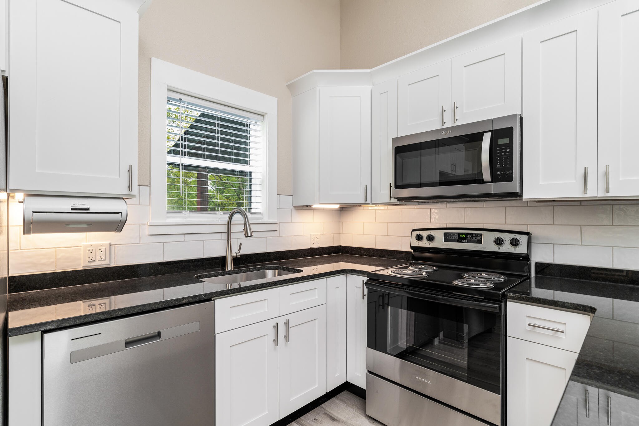 123 Englewood Road Athens, TN 37303 - Photo 14 of 62 a kitchen with granite countertop white cabinets appliances and a window