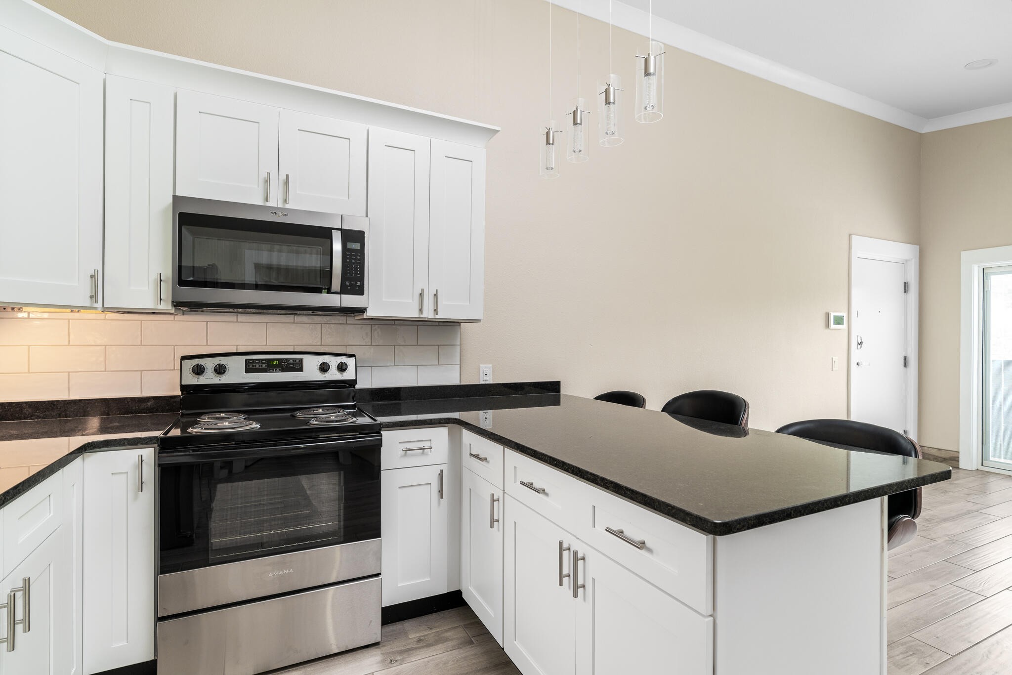 123 Englewood Road Athens, TN 37303 - Photo 15 of 62 a kitchen with granite countertop white cabinets and black appliances