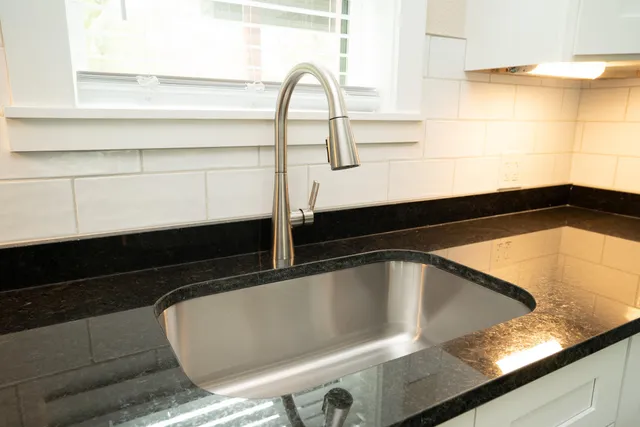a kitchen with a refrigerator and a sink