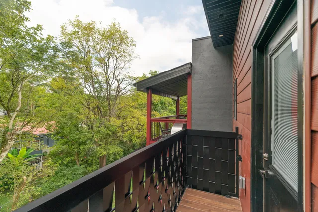 a view of balcony with chairs and wooden floor
