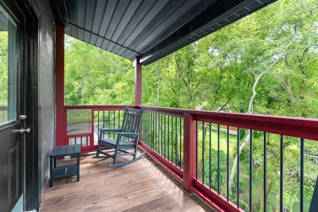 a view of empty room with wooden floor and fireplace