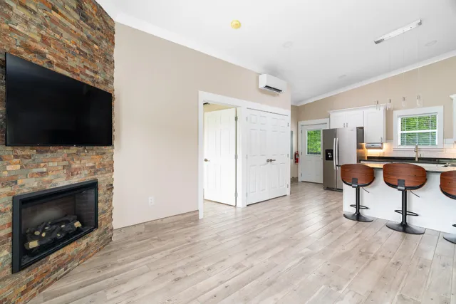 a view of empty room with wooden floor and fireplace