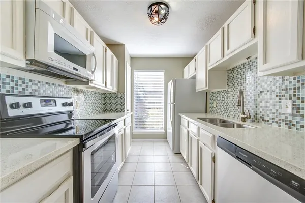 a kitchen with stainless steel appliances granite countertop a stove and a sink