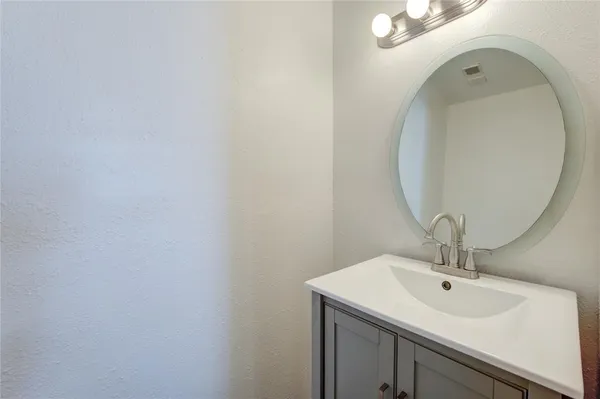 a bathroom with a sink and mirror