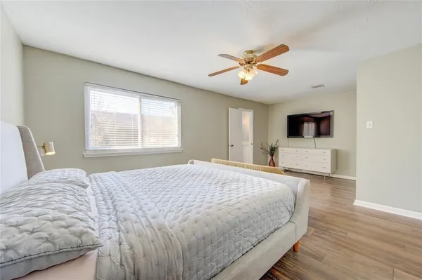 a bedroom with a large bed and a window