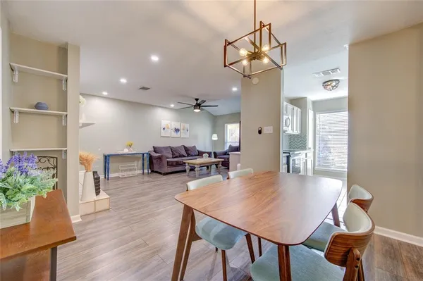 a view of a dining room with furniture and wooden floor
