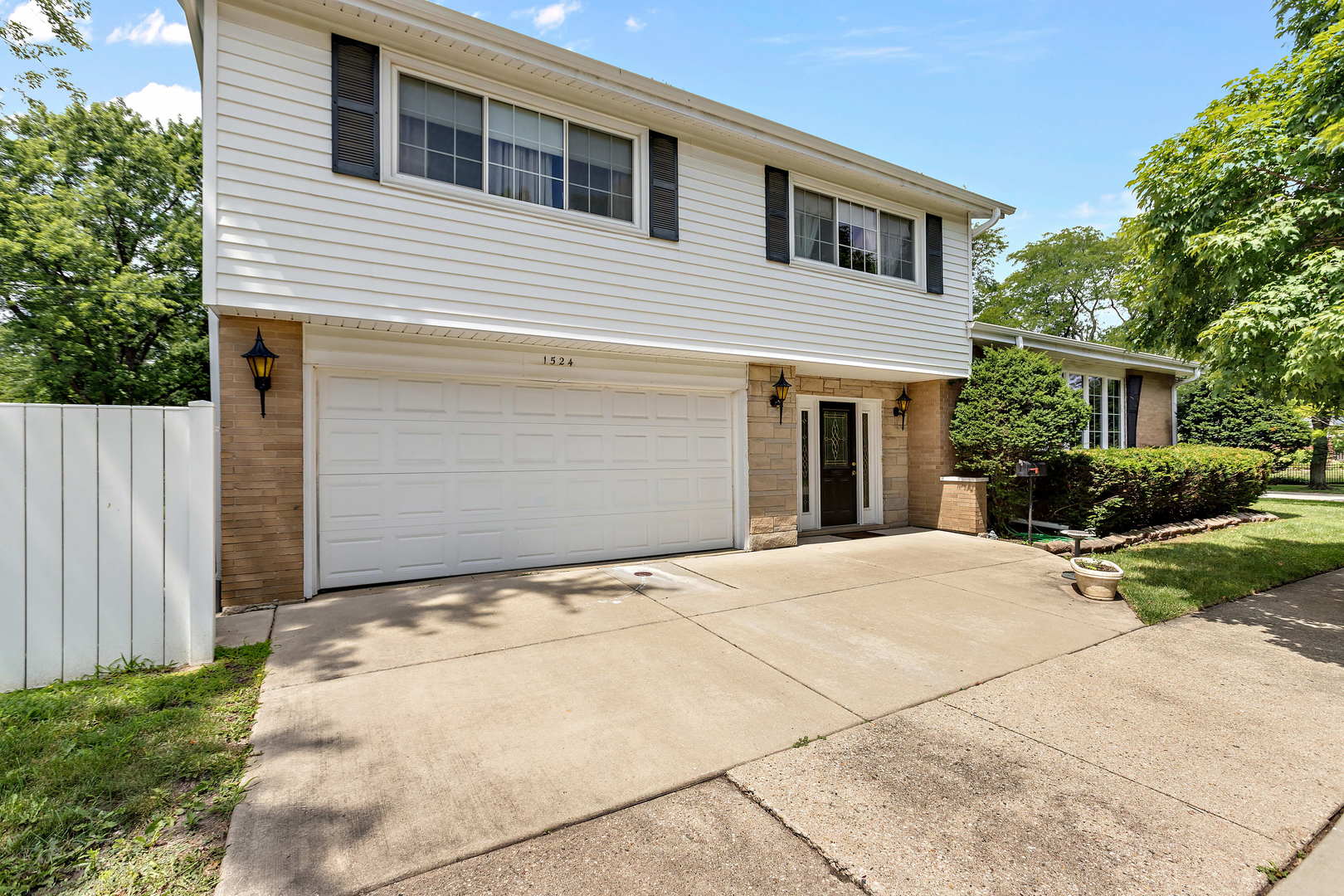 1524 Pfingsten Road Glenview, IL 60025 - Photo 1 of 26 a front view of a house with a yard and garage