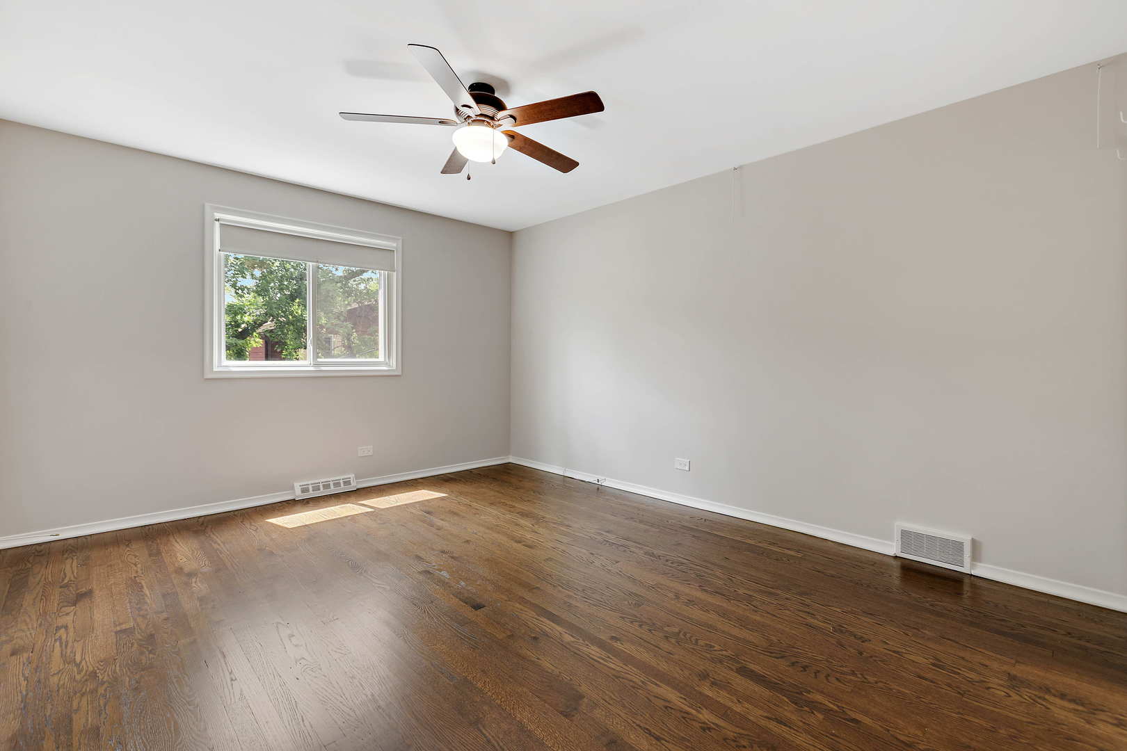 1524 Pfingsten Road Glenview, IL 60025 - Photo 17 of 26 a view of an empty room with wooden floor and a window