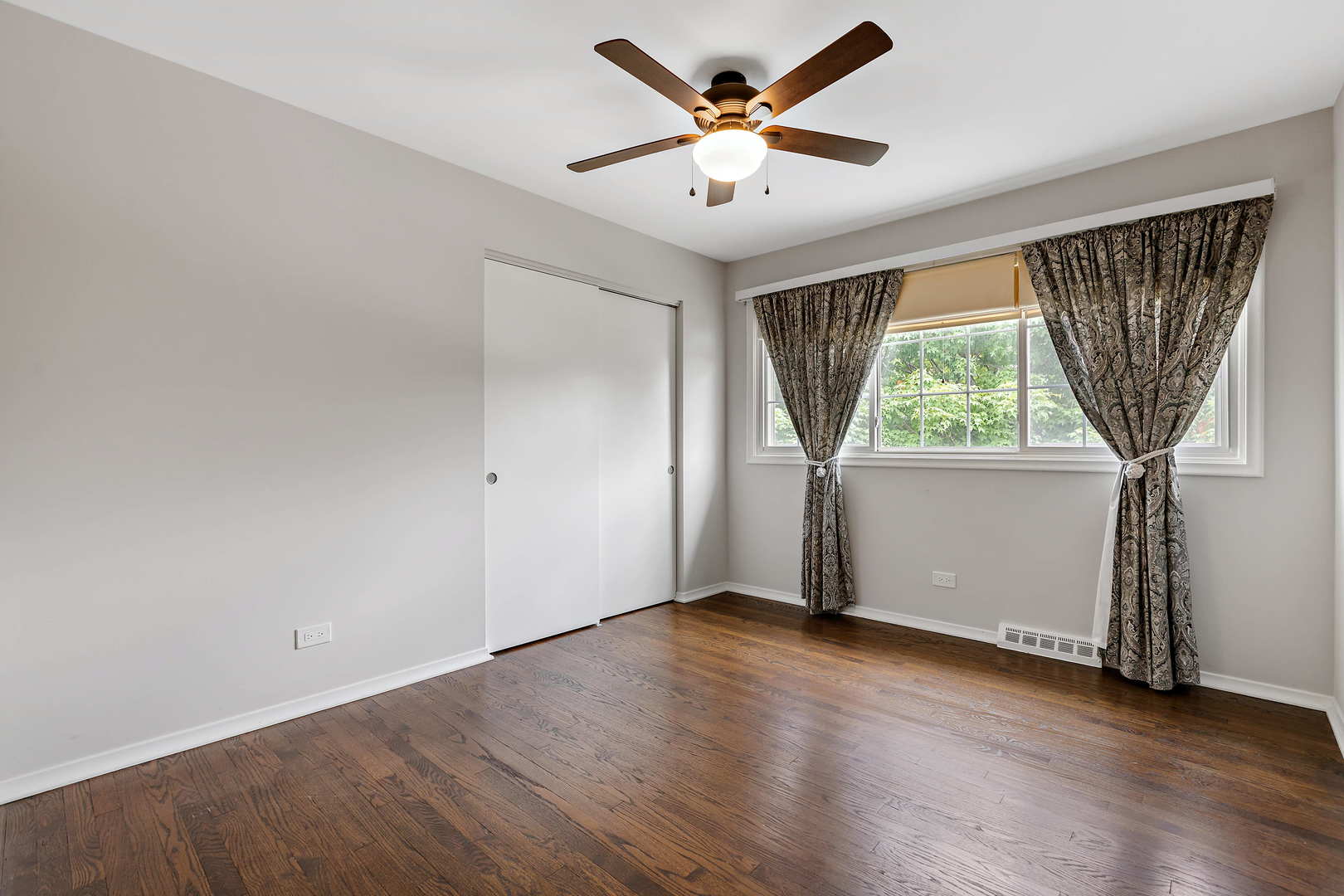 1524 Pfingsten Road Glenview, IL 60025 - Photo 18 of 26 an empty room with wooden floor and windows