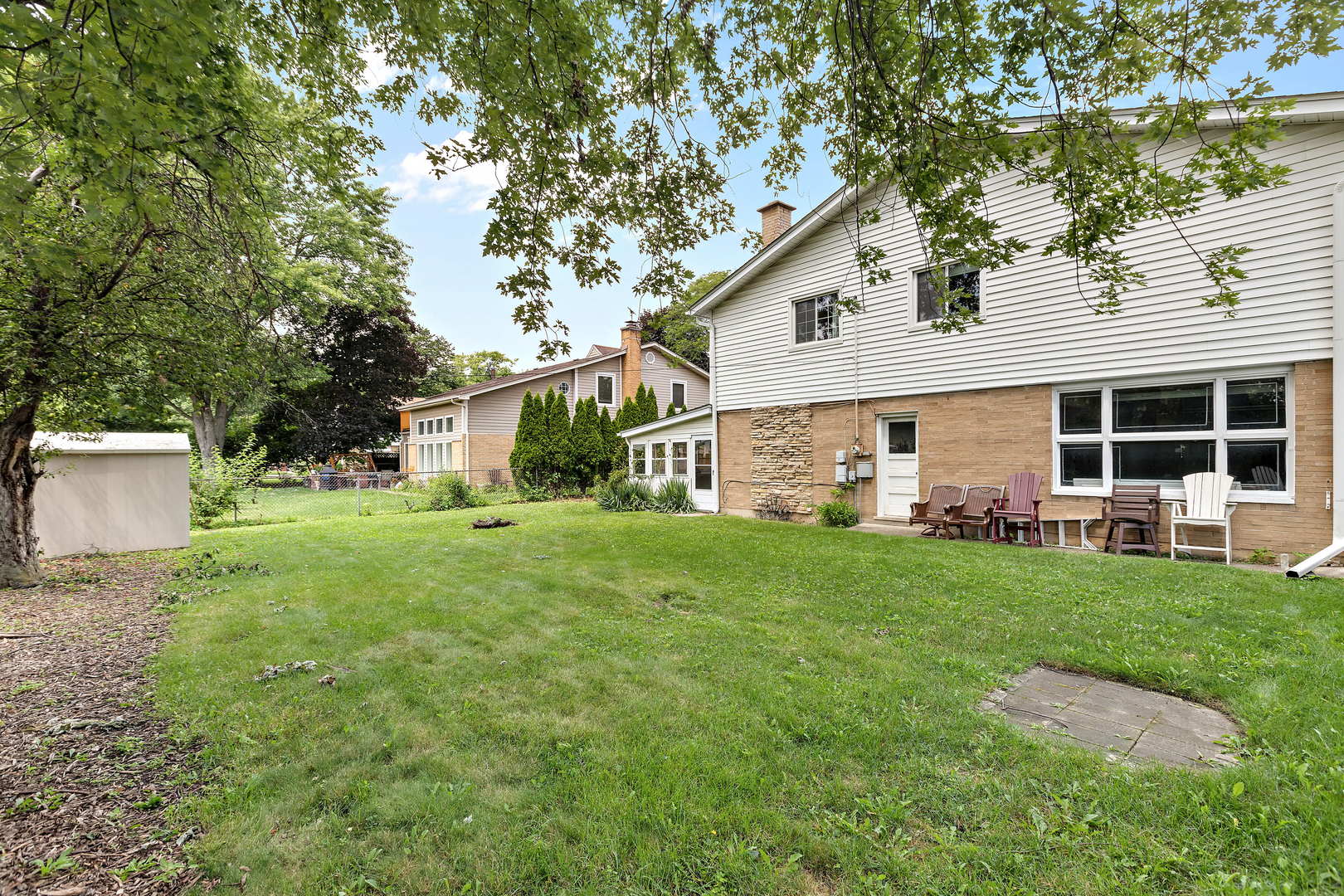 1524 Pfingsten Road Glenview, IL 60025 - Photo 23 of 26 a view of a house with backyard and a tree