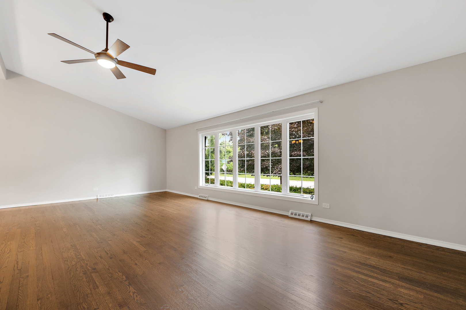 1524 Pfingsten Road Glenview, IL 60025 - Photo 3 of 26 a view of an empty room with wooden floor and a window