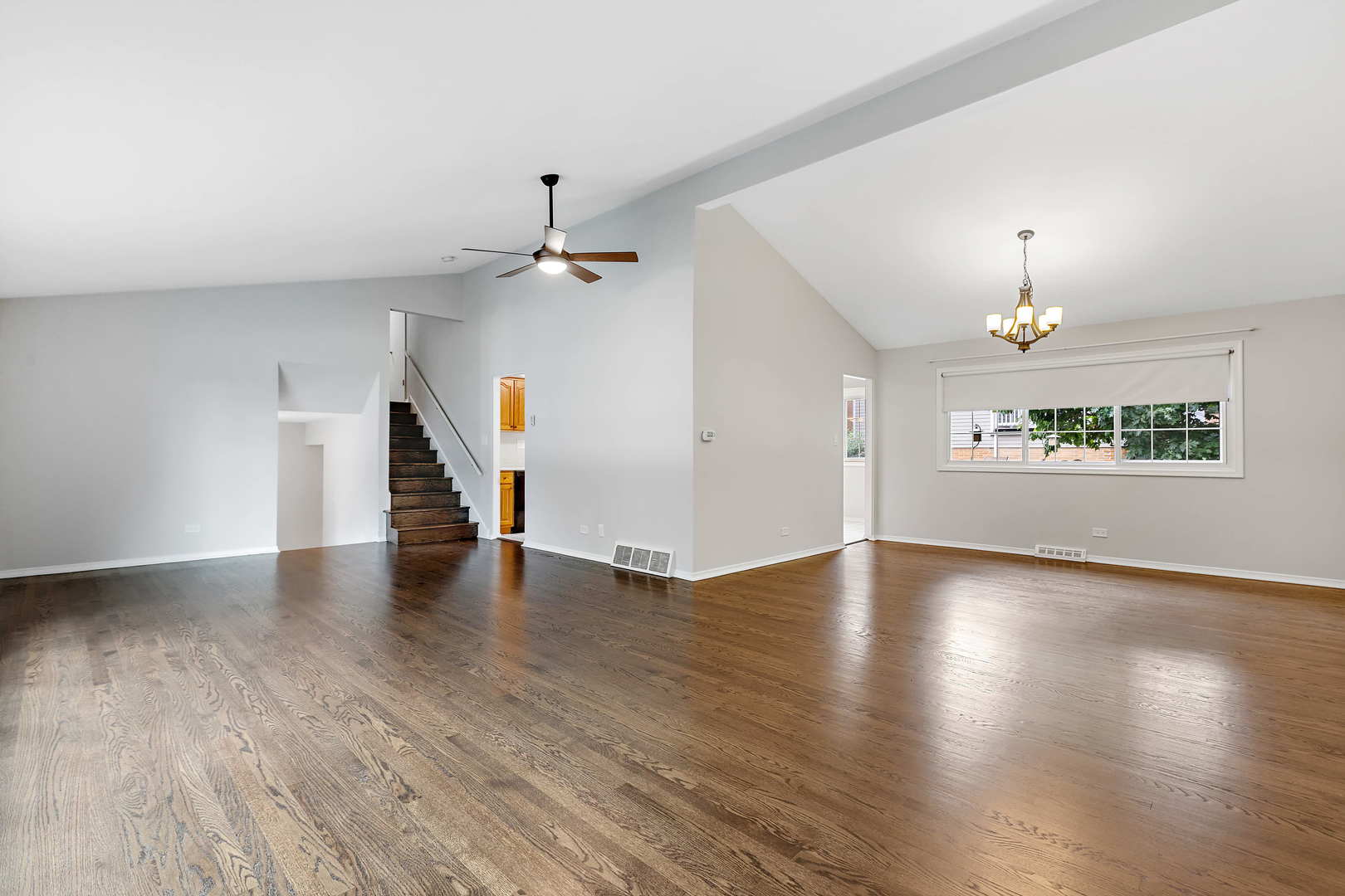 1524 Pfingsten Road Glenview, IL 60025 - Photo 6 of 26 an empty room with wooden floor chandelier and windows