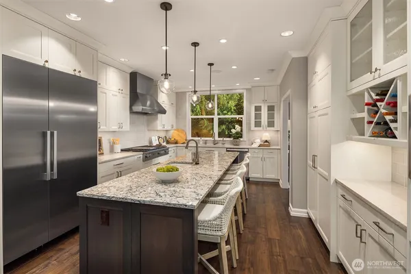 a kitchen with stainless steel appliances granite countertop a sink stove and cabinets