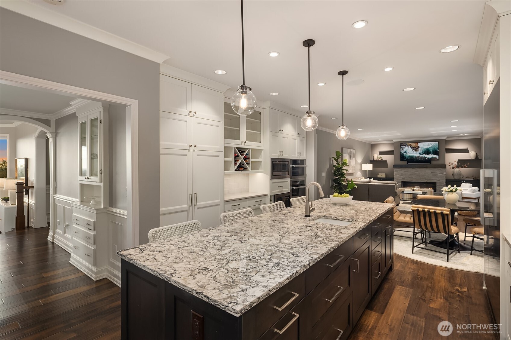 17620 Southeast 106th Street Renton, WA 98059 - Photo 15 of 40 a kitchen with stainless steel appliances kitchen island granite countertop a table chairs and a wooden floor