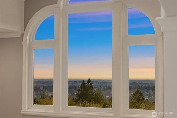 a living room with furniture a large window and a fireplace