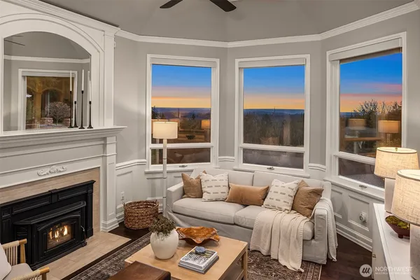 a living room with furniture ceiling fan and a large window