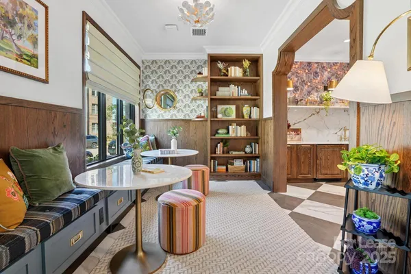 a living room with furniture and a potted plant
