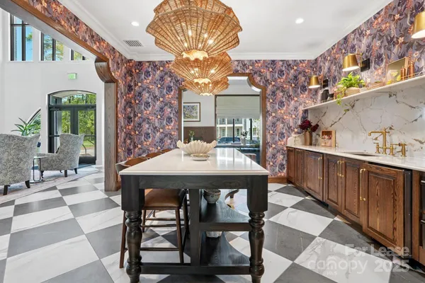 a view of a dining room with furniture and chandelier