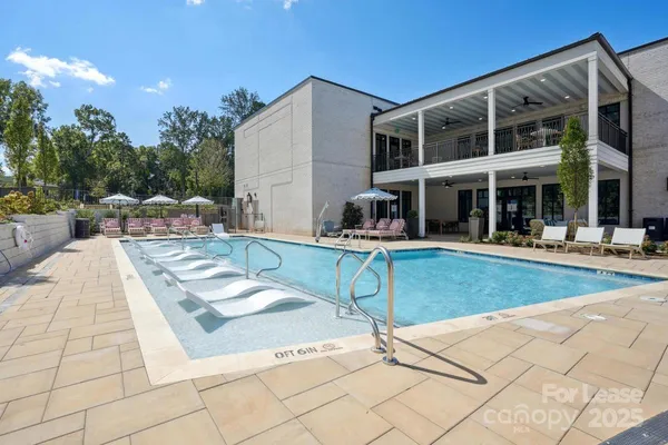 a view of a house with swimming pool and sitting area