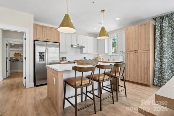 a view of a kitchen area with furniture and wooden floor