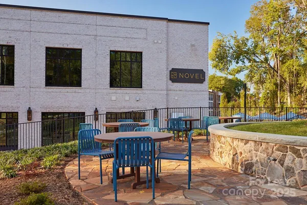 a view of a patio with table and chairs and potted plants