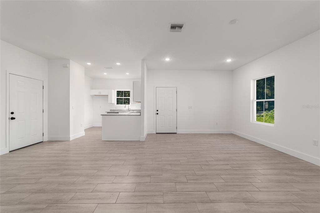 15431 Southwest 41st Street Road Ocala, FL 34481 - Photo 9 of 44 a view of a kitchen with furniture and wooden floor