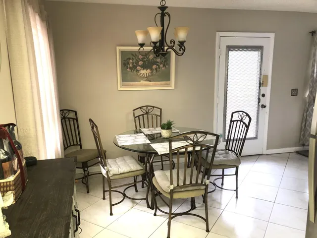 a view of a dining room with furniture and a window