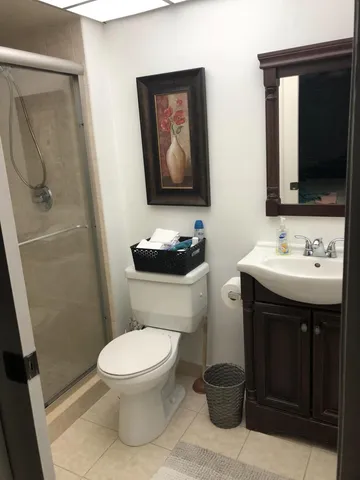 a bathroom with a toilet a sink and mirror