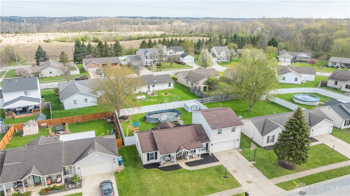 1442 Langdon Road Sidney, OH 45365 - Photo 5 of 34 An aerial perspective reveals a residential neighborhood nestled beside a scenic natural landscape.