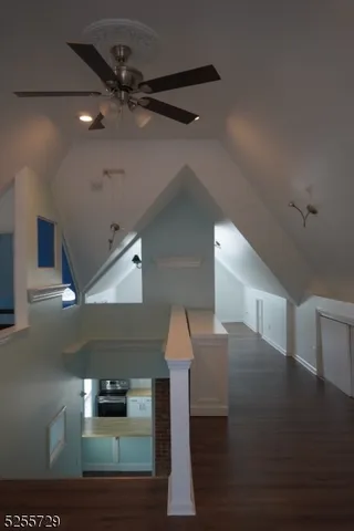 a view of a kitchen with wooden floor and electronic appliances