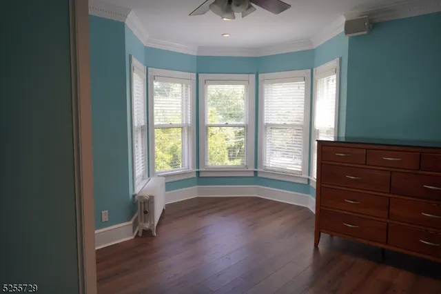 a view of room with wooden floor and fan