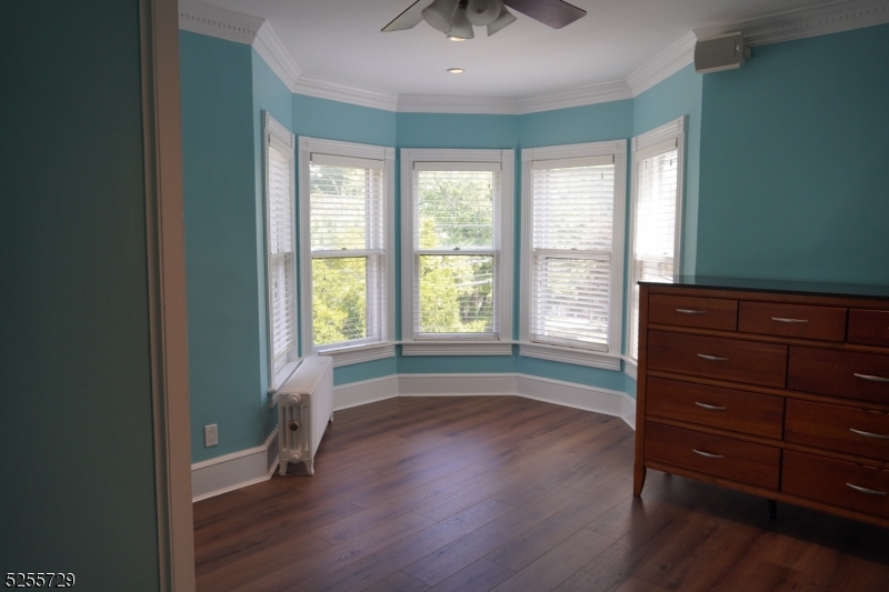 96 High Street Newton, NJ 07860 - Photo 5 of 26 a view of room with wooden floor and fan