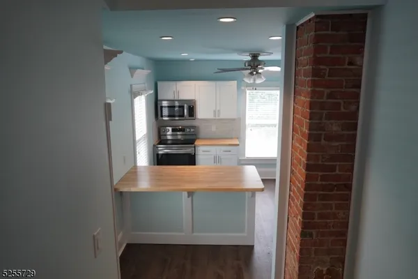 a view of kitchen with refrigerator stove and oven