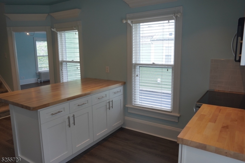 96 High Street Newton, NJ 07860 - Photo 8 of 26 a kitchen with granite countertop white cabinets and a wooden floor