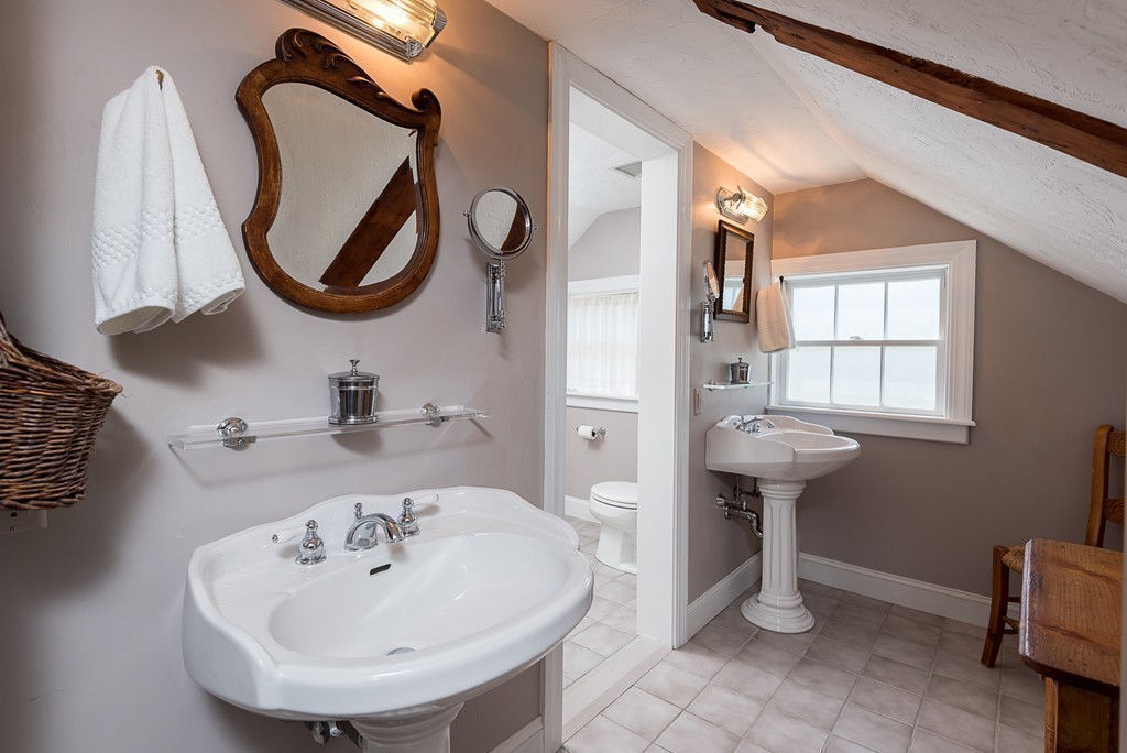 31 High Street Hingham, MA 02043 - Photo 18 of 29 a bathroom with a sink and a mirror