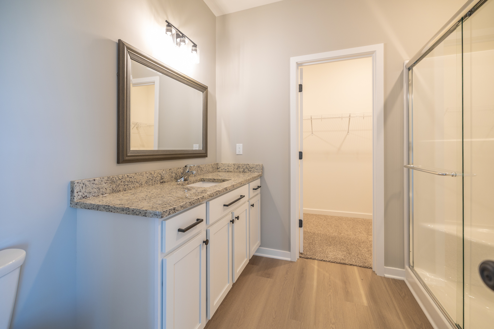 12 Redbud Row Ottawa, IL 61350 - Photo 17 of 39 a bathroom with a granite countertop sink a mirror and a shower