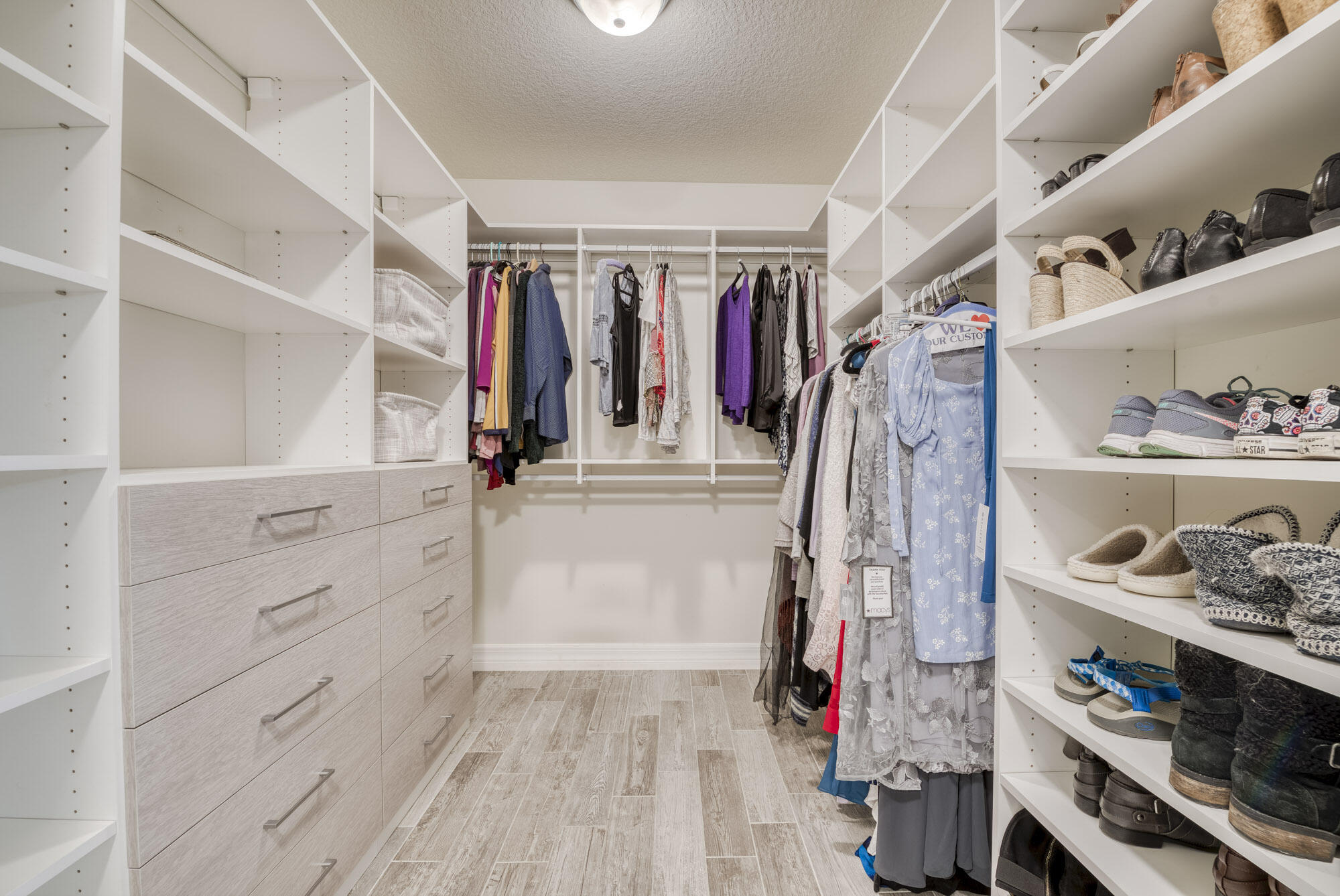 117 Croft Inlet Point Jupiter, FL 33478 - Photo 13 of 53 a view of walk in closet with clothes and shoes