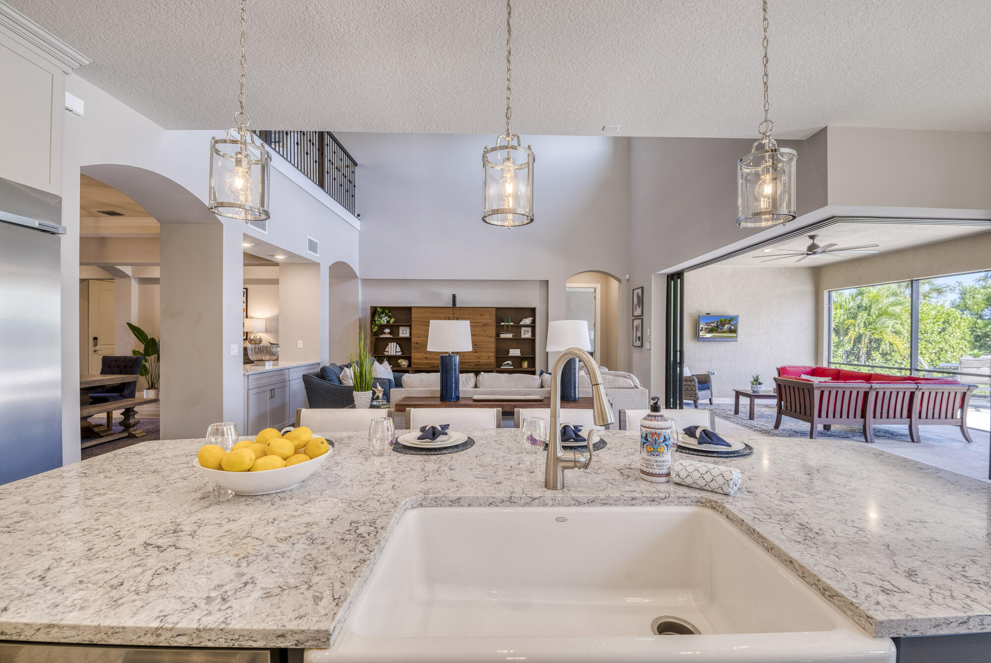 117 Croft Inlet Point Jupiter, FL 33478 - Photo 29 of 53 a kitchen with a sink a counter top space and living room view