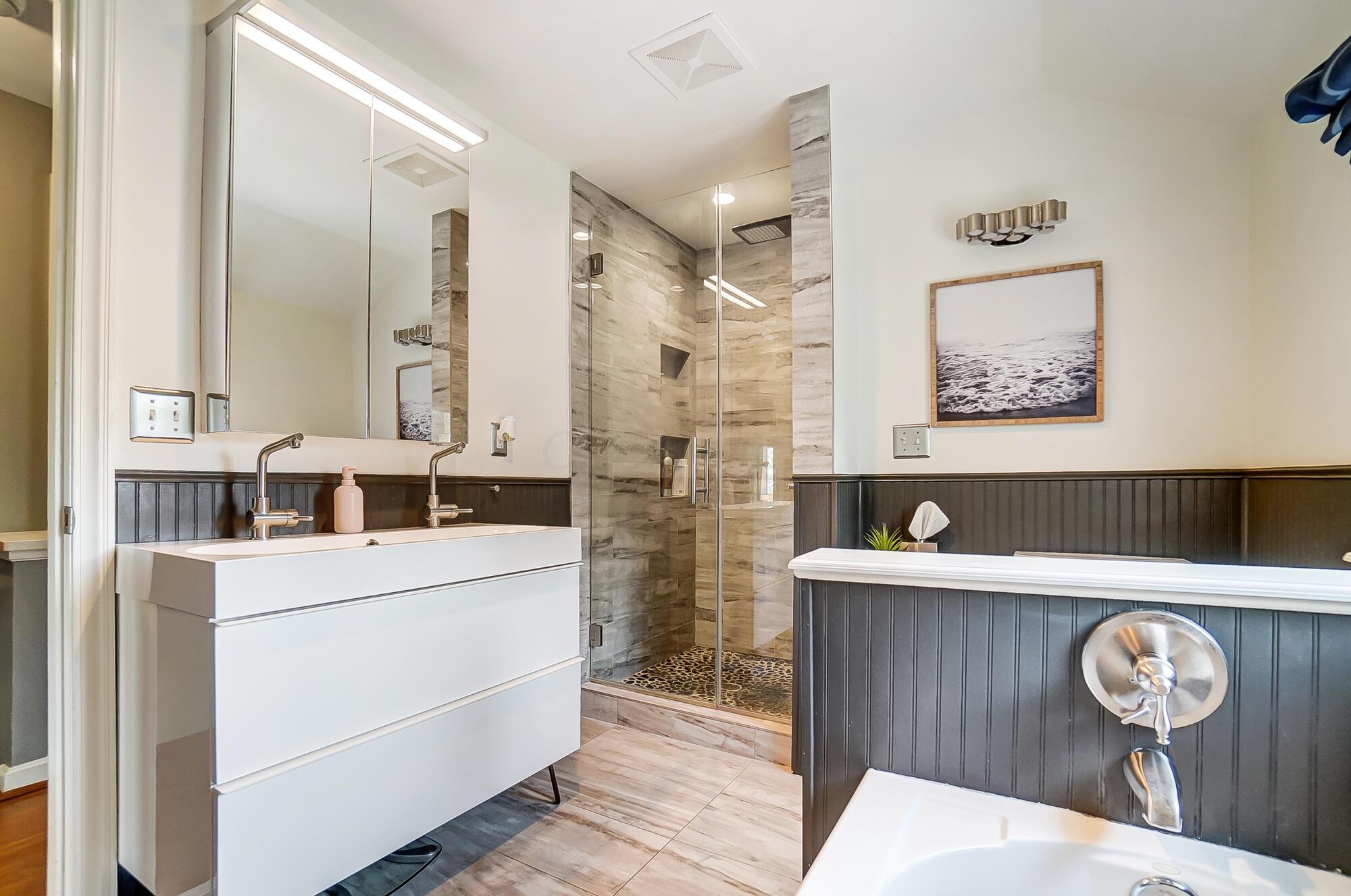 1539 Cardiff Road Columbus, OH 43221 - Photo 29 of 45 This bath has been updated and it looks very nice. It has a bath tub, tiled shower, custom vanity and natural light!