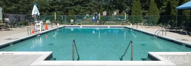 a view of a lake with a yard and large trees