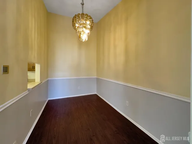 a view of room with window and wooden floor