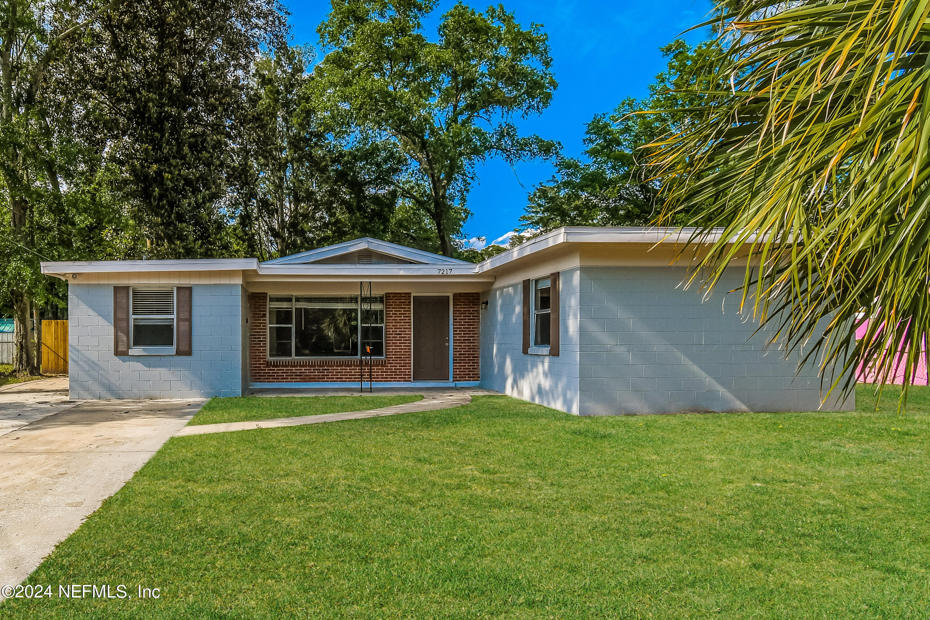 a front view of house with yard and green space
