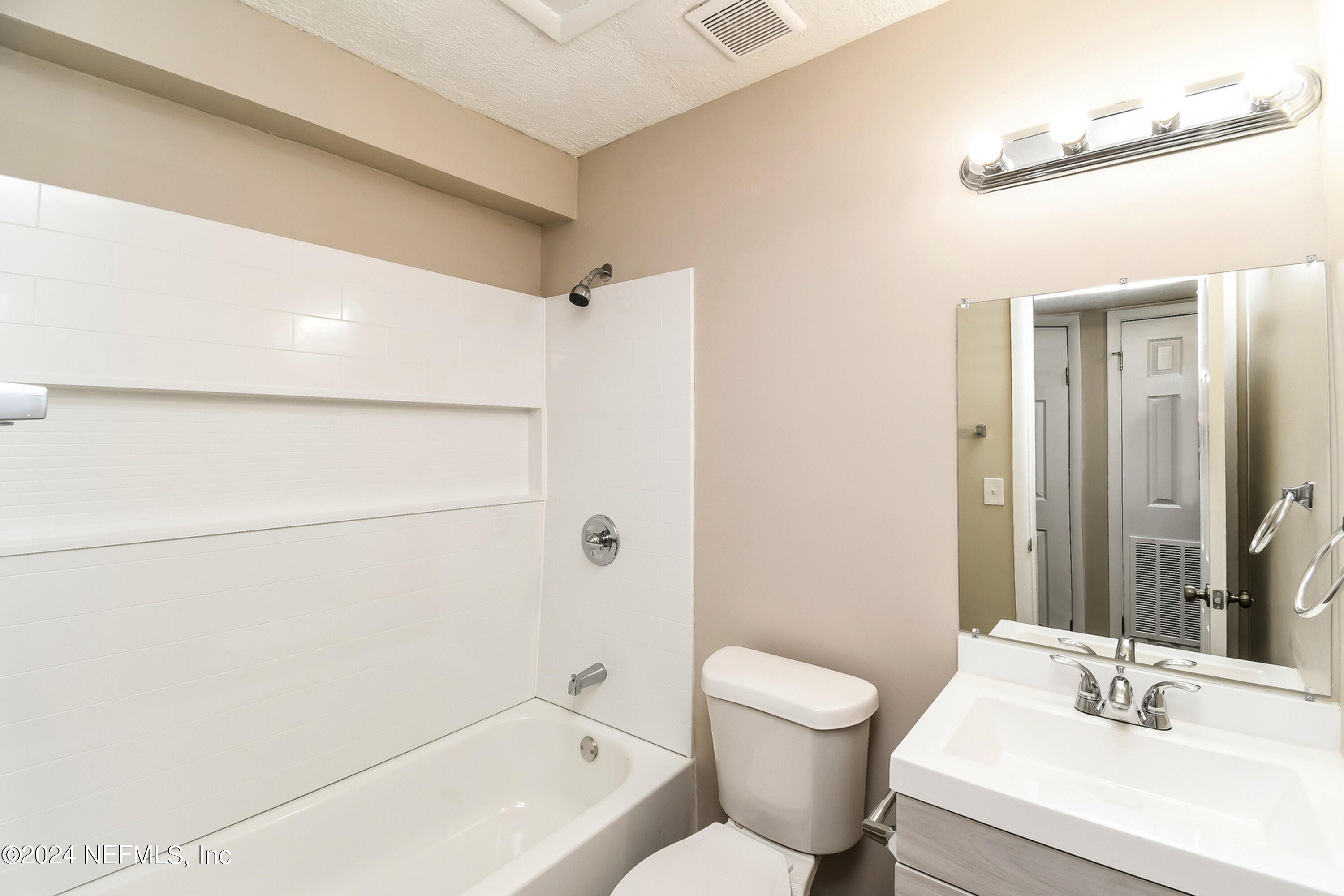 7217 Eudine Drive South Jacksonville, FL 32210 - Photo 14 of 16 a bathroom with a toilet a sink and a bathtub